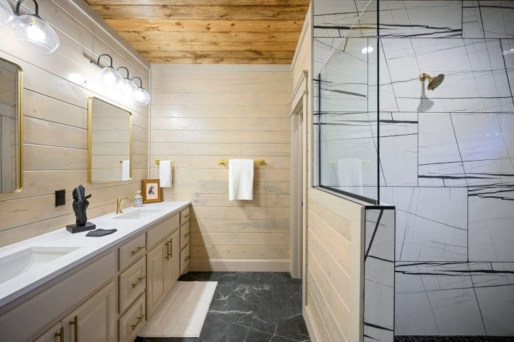 Vanity next to a walk-in shower with a tile floor