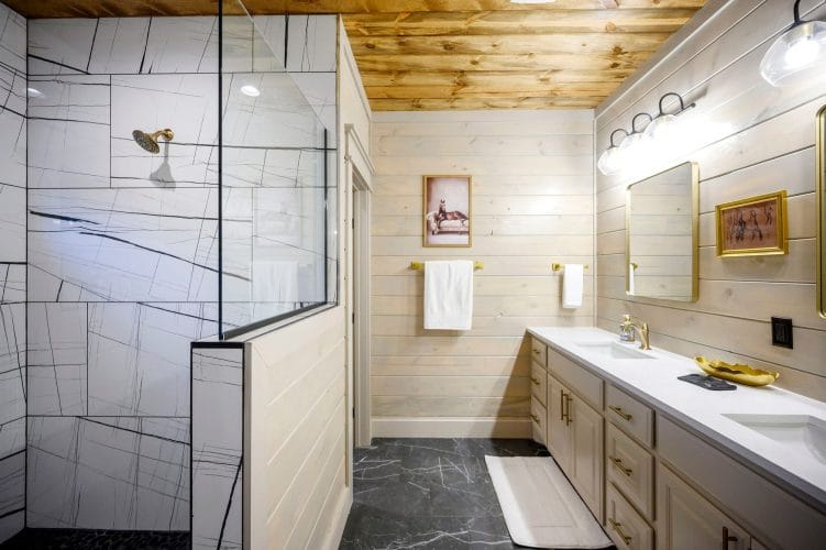 Vanity with a framed horse picture beside the shower glass