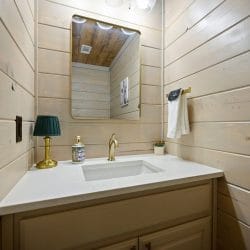 Single vanity with a framed mirror and a small lamp