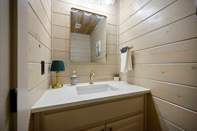 Single vanity with a framed mirror and a small lamp