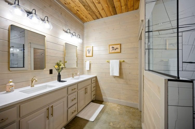Double vanity with a window and a vase of flowers