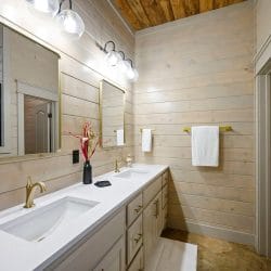 Vanity with a wall mirror and gold fixtures