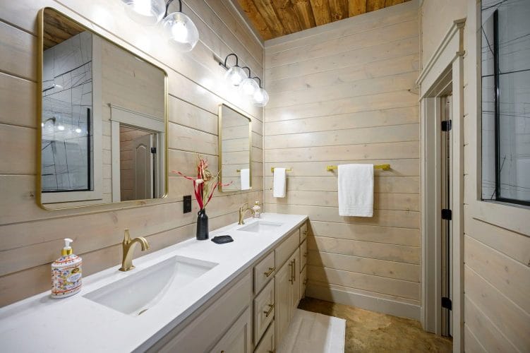 Vanity with a wall mirror and gold fixtures