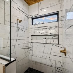 Glass walk-in shower with a built-in niche