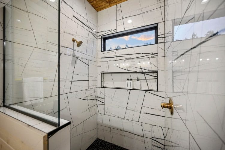 Glass walk-in shower with a built-in niche