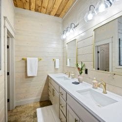 Double vanity with a gold-framed mirror