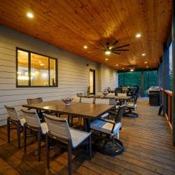 Long outdoor dining table on the covered deck