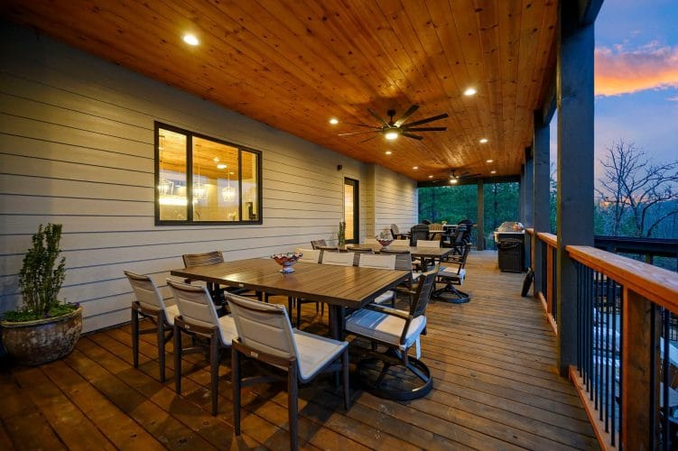 Long outdoor dining table on the covered deck
