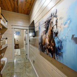 Hallway with a large horse painting and bunk beds along one wall
