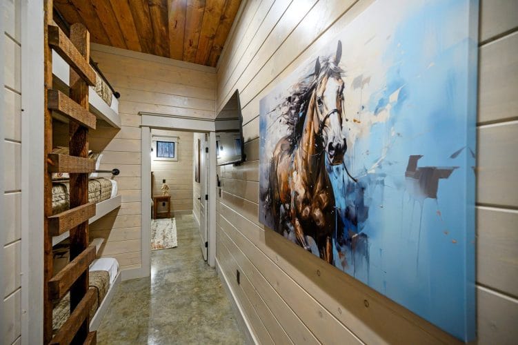 Hallway with a large horse painting and bunk beds along one wall