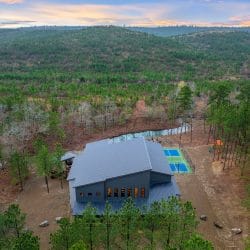 Aerial view of the lodge roof and sports court in the forest