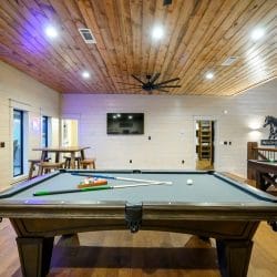 Pool table and a seating area with sliding doors to the balcony