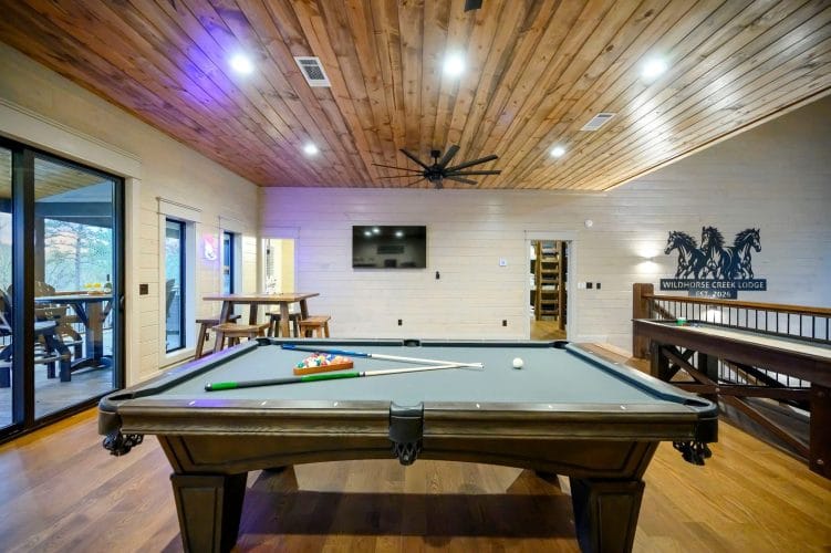 Pool table and a seating area with sliding doors to the balcony