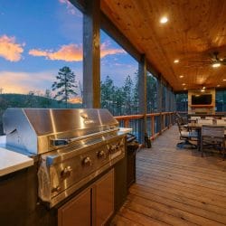 Built-in stainless grill with a counter on the covered deck