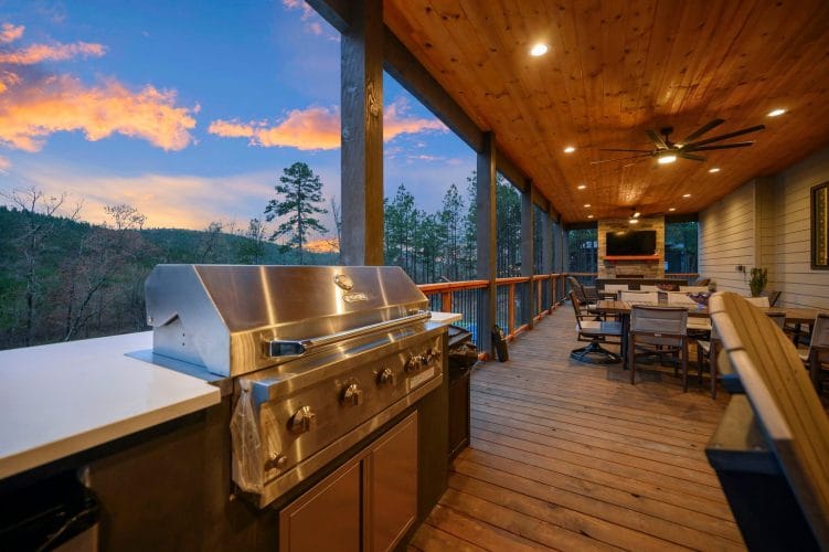 Built-in stainless grill with a counter on the covered deck