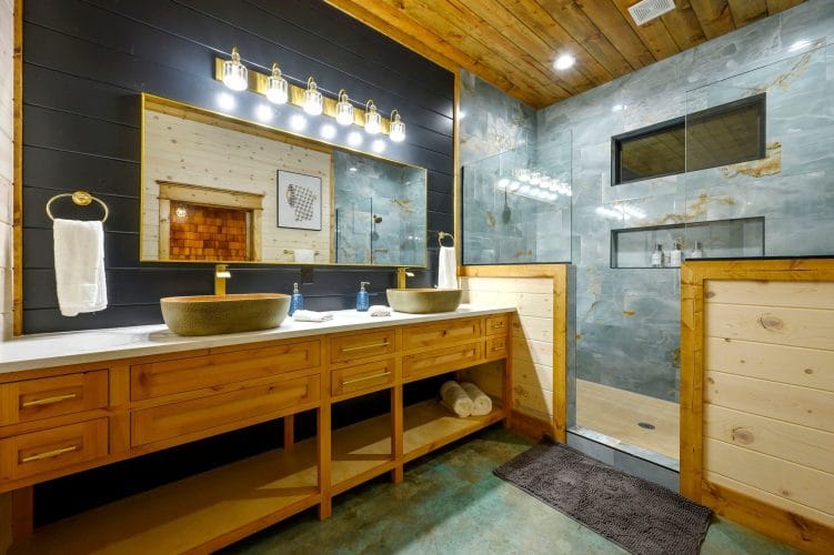 Double vanity with bowl sinks and a tile shower