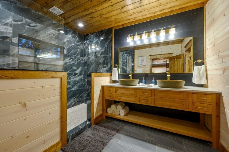 Double vanity with bowl sinks and a large tile shower