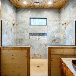Tile shower with a window and a bowl sink