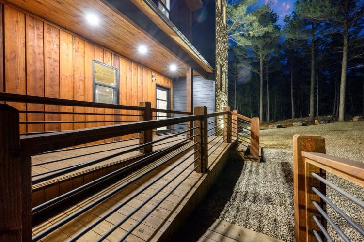 Deck railing along the side of the house at night