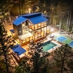 Night aerial of the house, pool and lit court