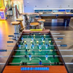 Foosball table with the game room beyond