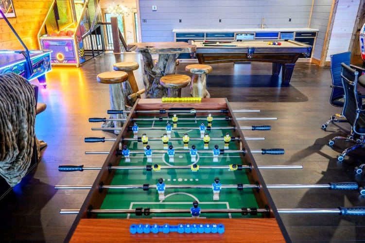 Foosball table with the game room beyond