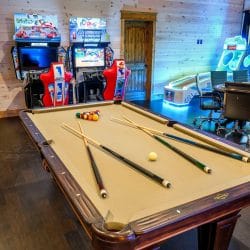 Pool table with racing arcade machines and a conference-style table