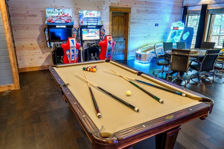 Pool table with racing arcade machines and a conference-style table