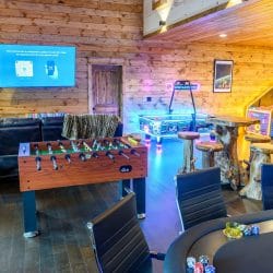 Foosball table, poker table and neon lights in the game room