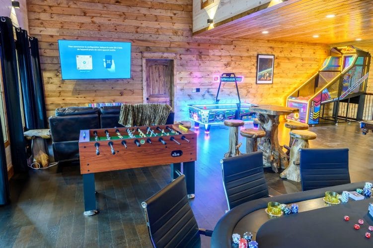 Foosball table, poker table and neon lights in the game room