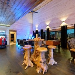 Game room with arcade machines, stump stools and high windows