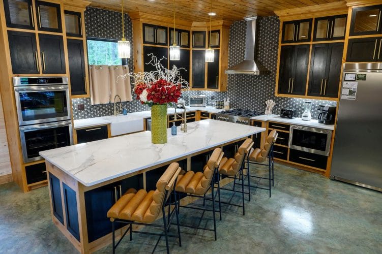 Large island with leather bar stools and double wall ovens
