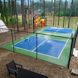 Fenced pickleball and basketball court beside the pool