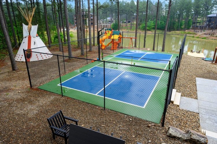 Fenced pickleball and basketball court beside the pool