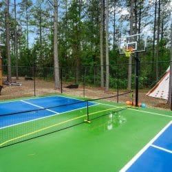 Court with a basketball hoop, net and the teepee behind