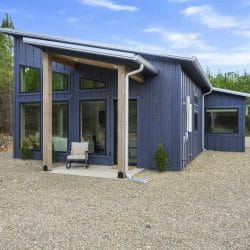 Side view of the cabin's big glass windows and covered entry