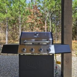 Gas grill on the patio looking out to the pines