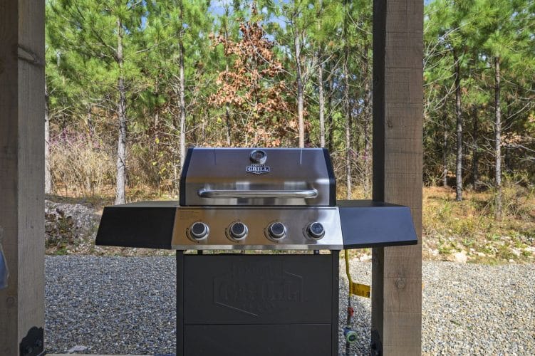 Gas grill on the patio looking out to the pines