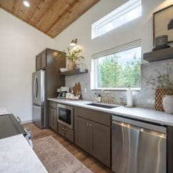 Kitchen counter, dishwasher and microwave under a high window
