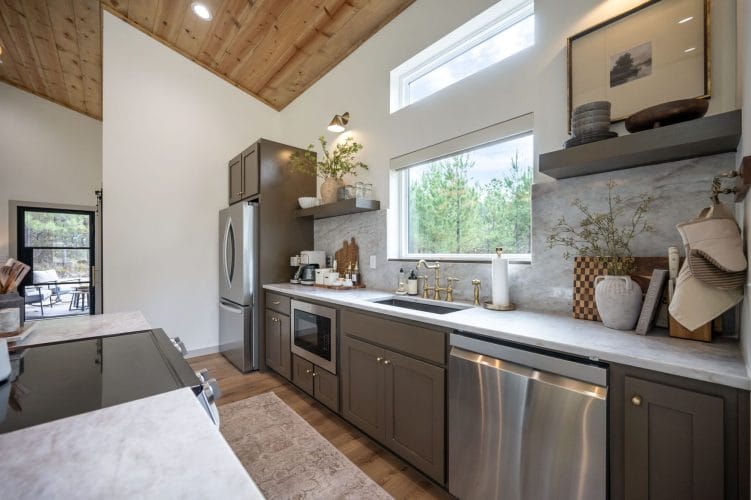 Kitchen counter, dishwasher and microwave under a high window