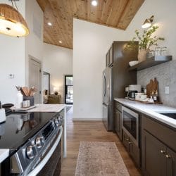 Electric range with a kettle and utensil crock, kitchen counter beyond