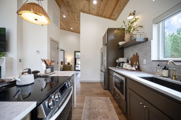 Electric range with a kettle and utensil crock, kitchen counter beyond