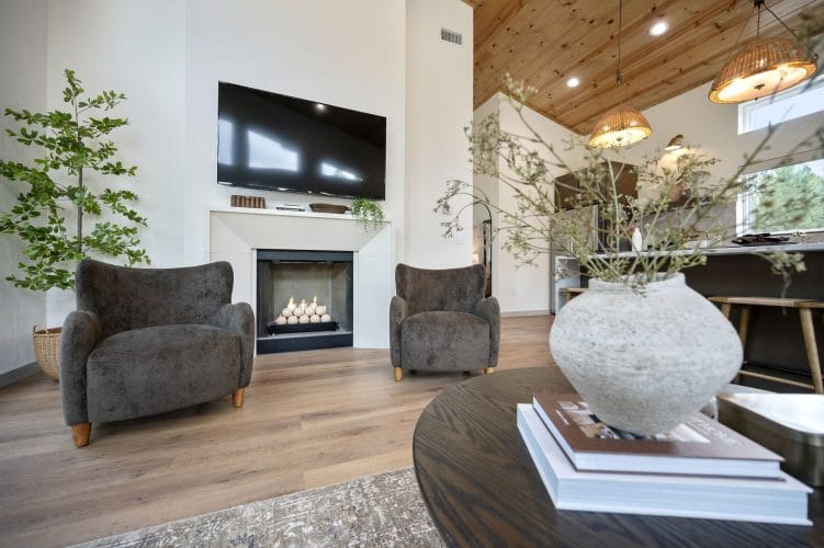 Fireplace with two gray armchairs under the TV