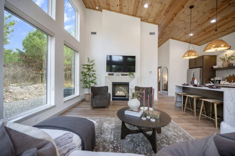 Living room seen from the sofa toward the fireplace and kitchen
