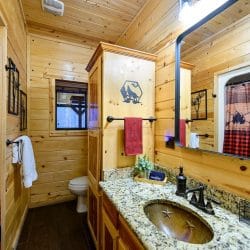 Bathroom vanity with a granite top and a small window