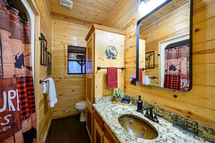 Bathroom vanity with a granite top and a small window