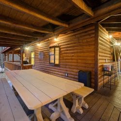 Long wooden picnic-style table on the deck