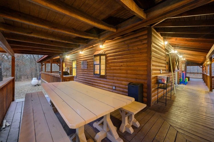 Long wooden picnic-style table on the deck