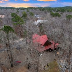 Aerial of the cabin and the play area in the woods