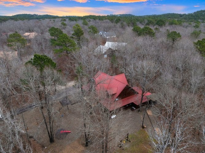 Aerial of the cabin and the play area in the woods